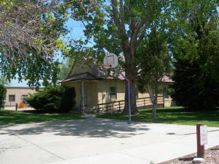 small building with basketball hoop outside